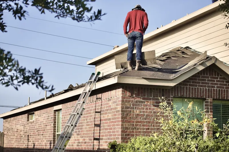 Professional roofer working on a residential roof in Rosaryville